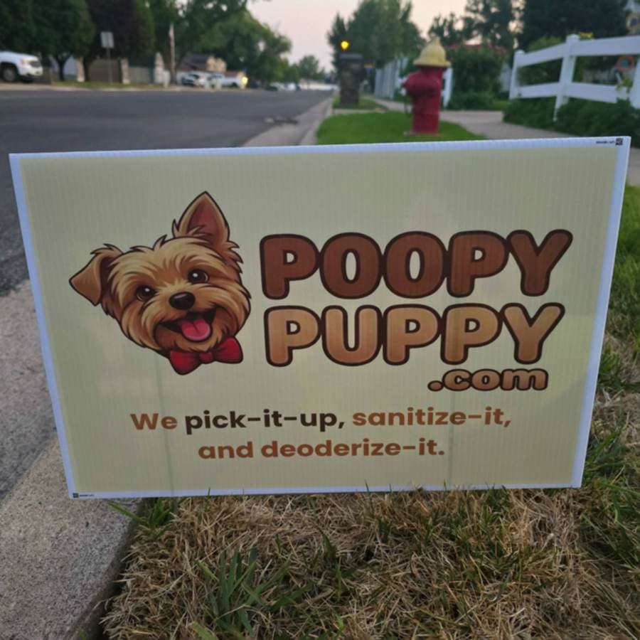A Poopy Puppy yard sign standing in a freshly cleaned Layton lawn